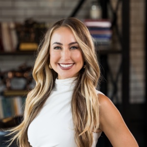 a headshot of Jenna Ahern in a white dress