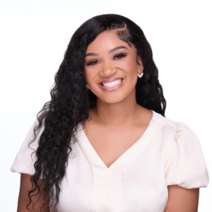 A headshot of Shermiah Holland in a white shirt